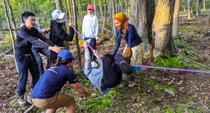 a group of teams participate in a team building exercise on an outward bound trip